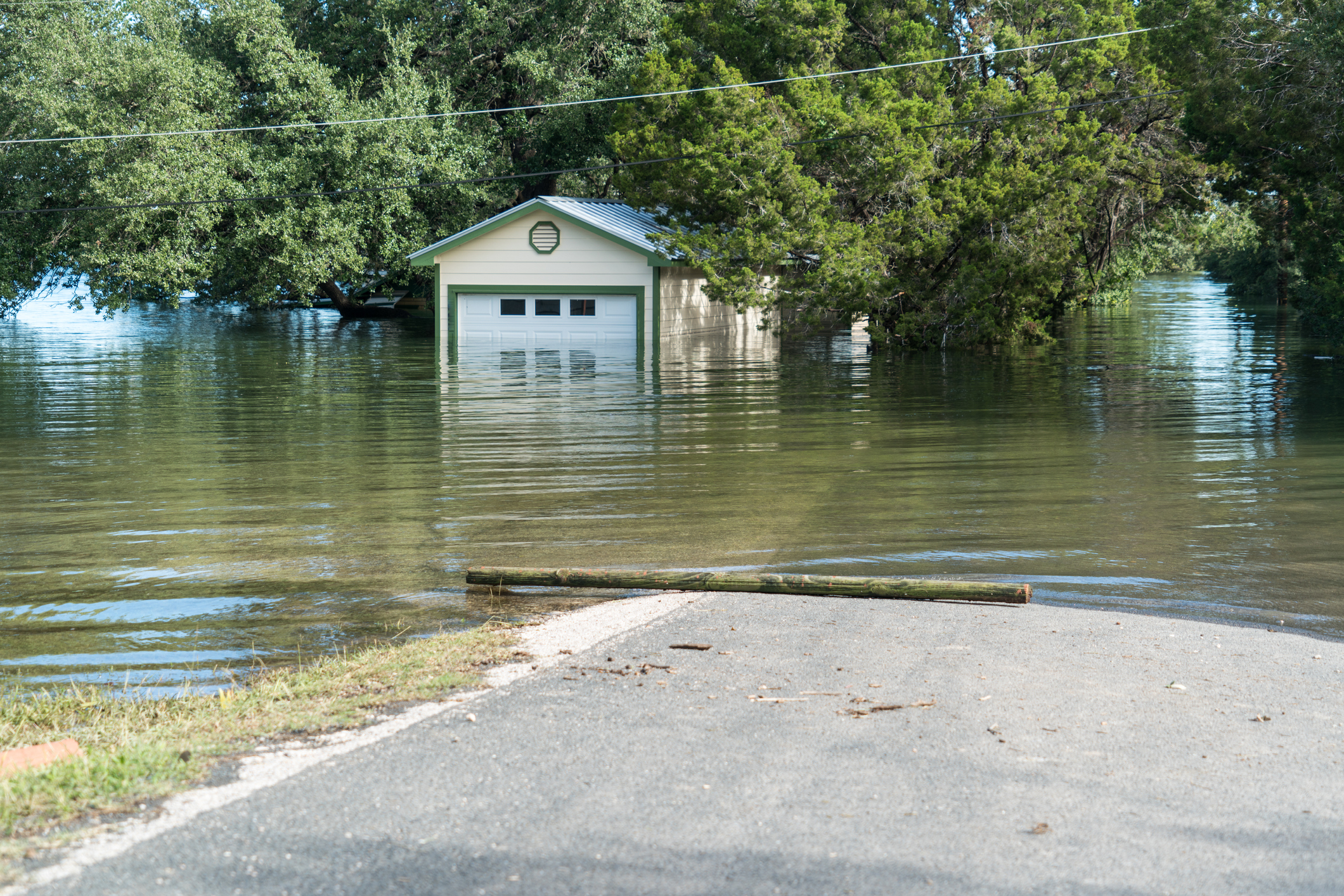 A flooded house and road in Austin, Texas