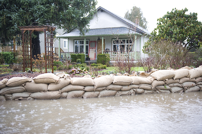 Sandbags protect a home from flood during a storm.