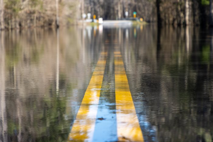 flooded highway with the marker sign visible